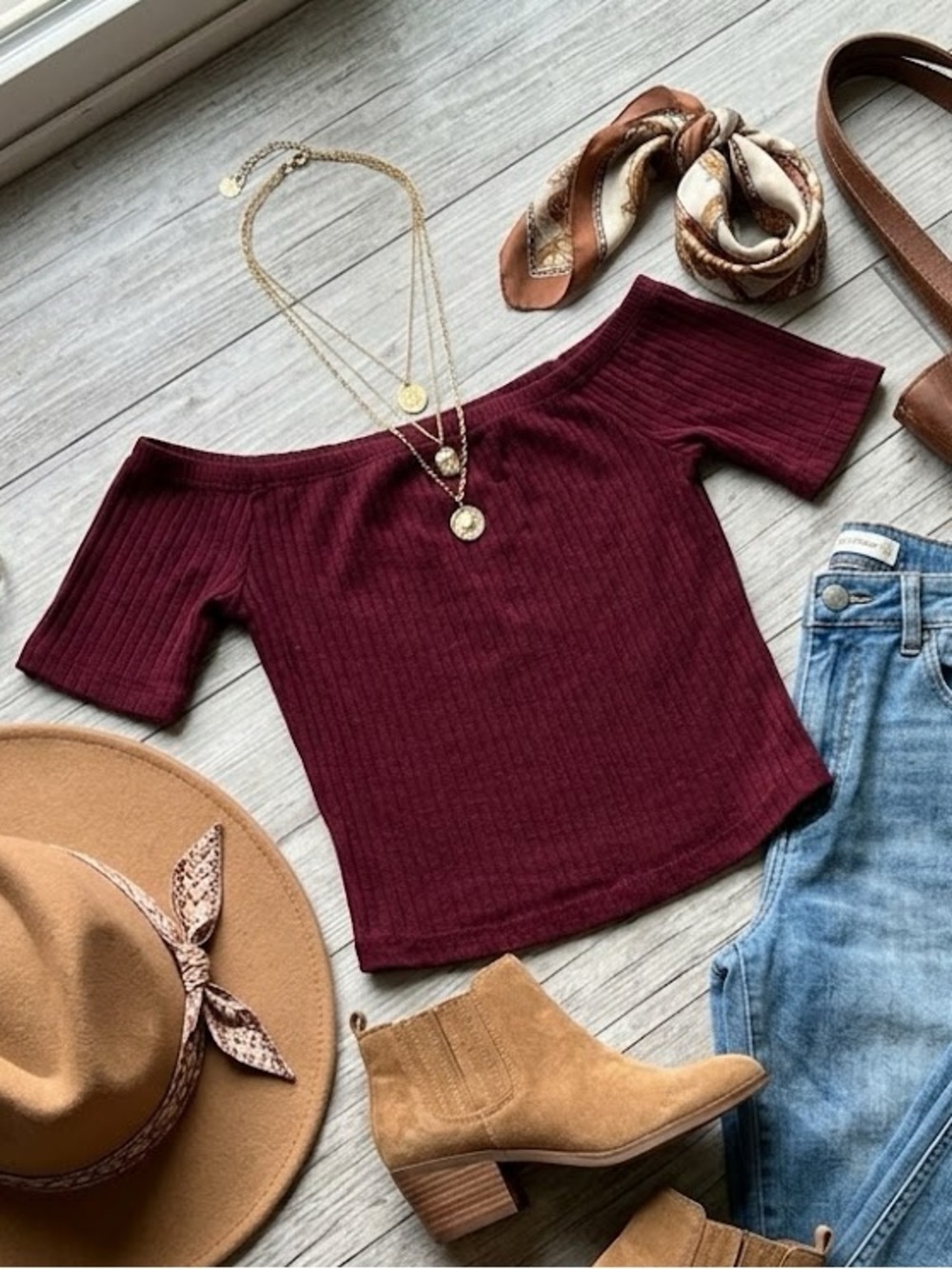 A maroon off-the-shoulder crop top.